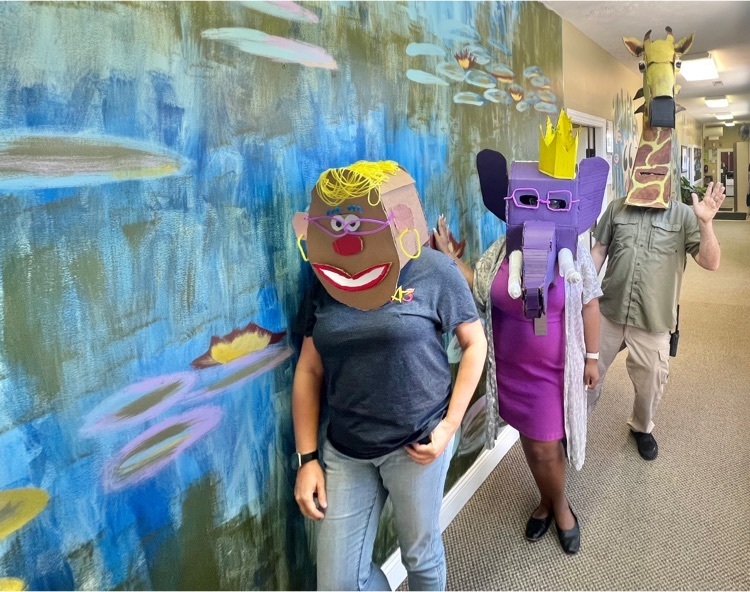 teachers in cardboard masks-Mrs potato head, purple elephant, giraffe