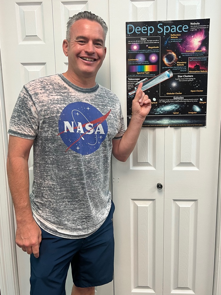 Mr Kendall with nasa shirt by space poster